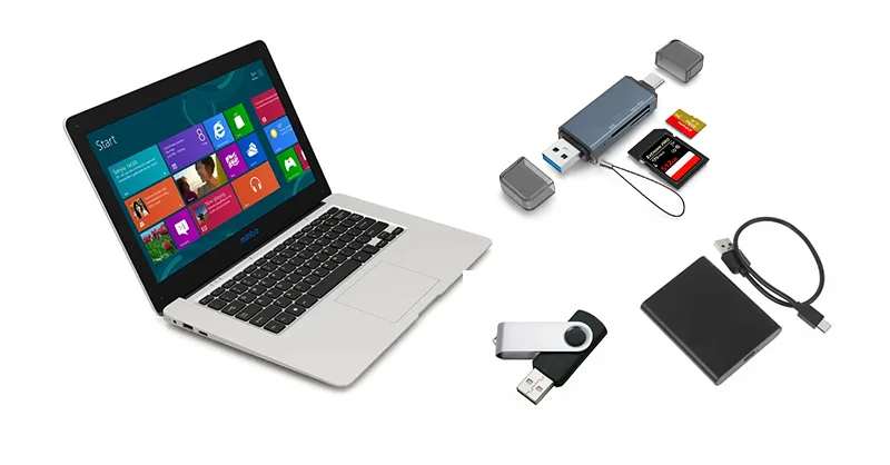 Formater un support : image, photo représentant un ordinateur portable ouvert, avec une clé USB, un disque dur externe et une carte SD posés à côté.